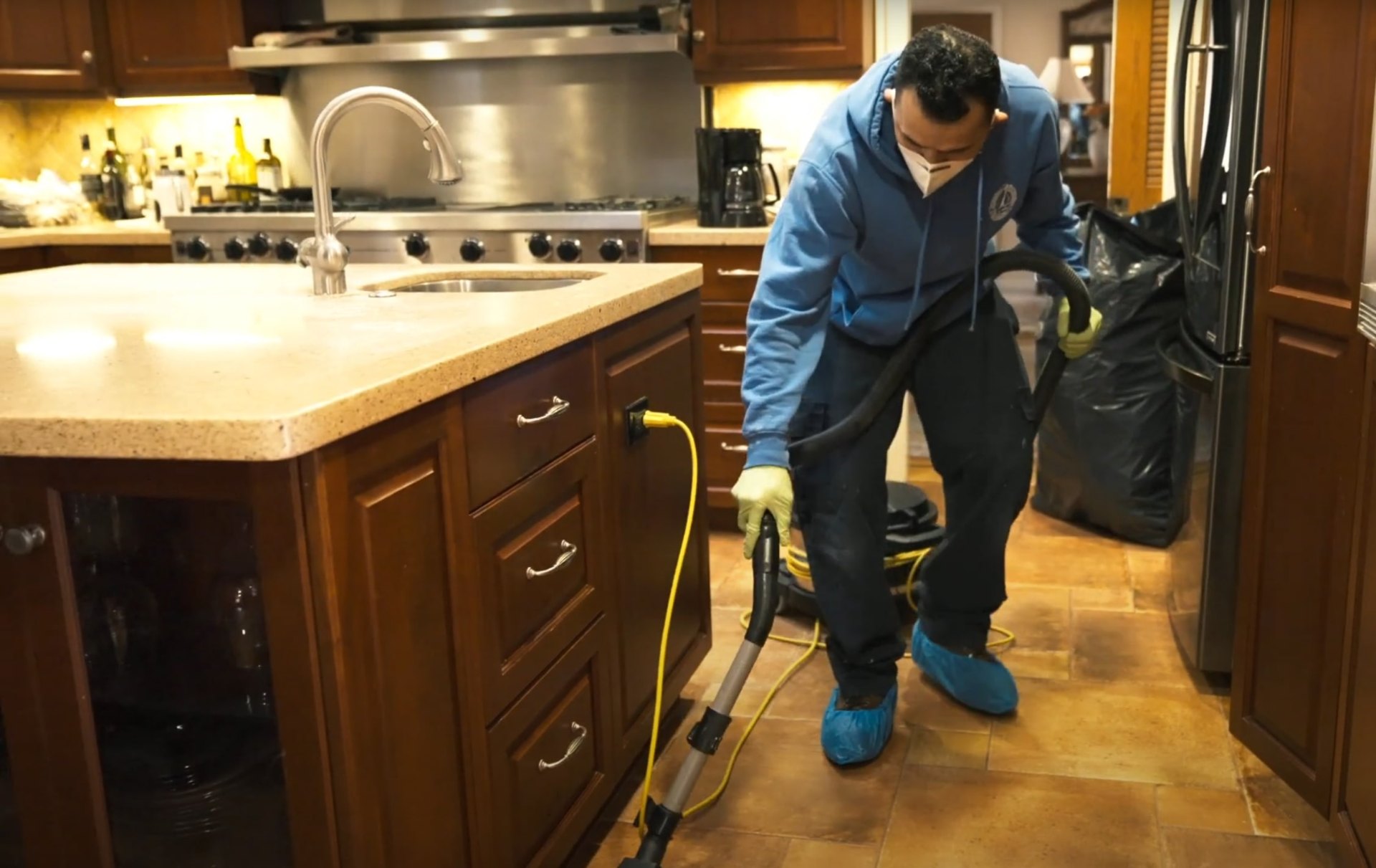 Professional water extraction and cleaning services in Midlothian residential kitchen Water damage restoration professional cleaning and extracting water from kitchen with industrial equipment
